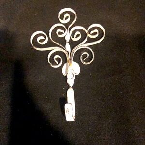 METAL SWIRLY HOOK.7” long by 4 1/2” wide..DISTRESSED FINISH.WHITE & METAL